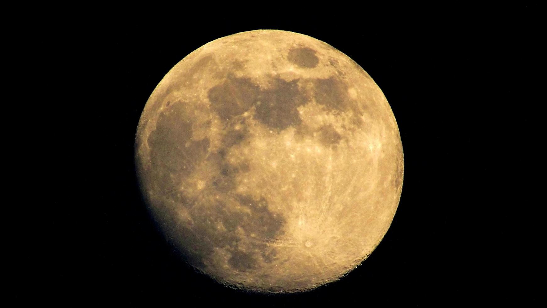 lua cheia no céu noturno. lua no fundo preto foto