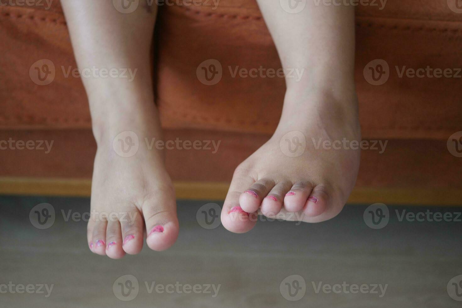Os pés da menina da criança de 5 anos fecham-se foto