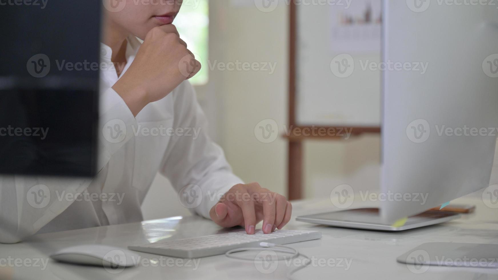 mão do homem no teclado e olha para a tela do computador. foto