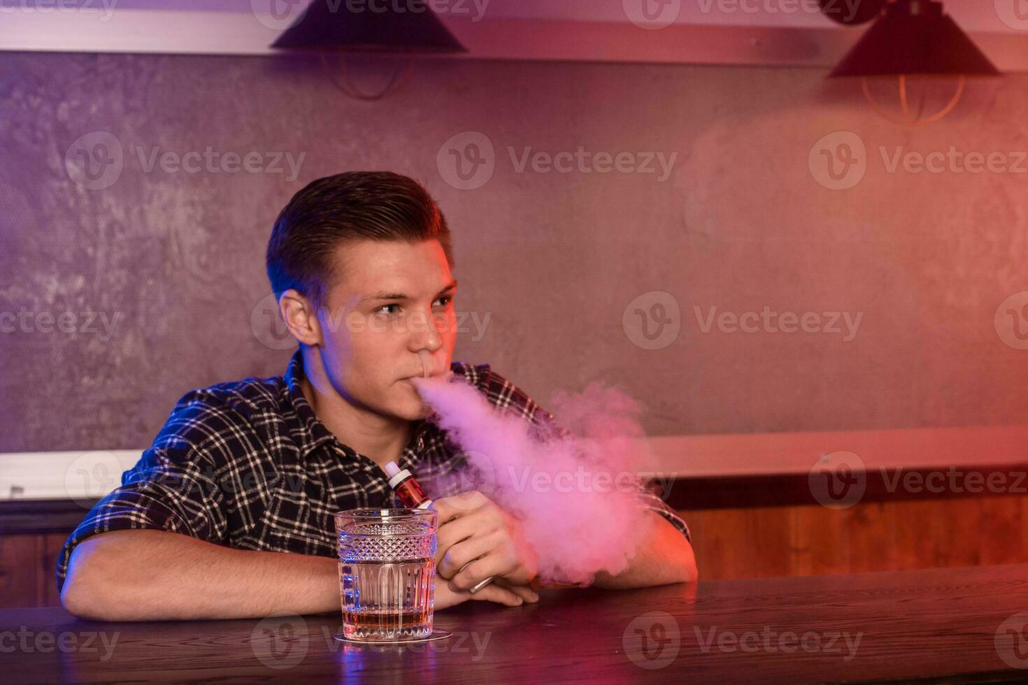 a homem fumaça a eletrônico cigarro às a vape fazer compras. foto