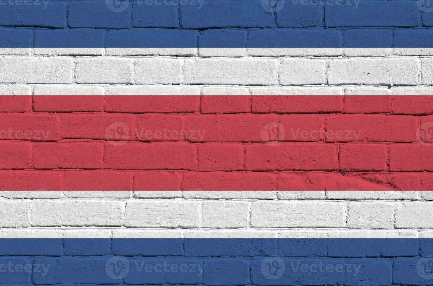 costa rica bandeira retratado dentro pintura cores em velho tijolo muro. texturizado bandeira em grande tijolo parede alvenaria fundo foto