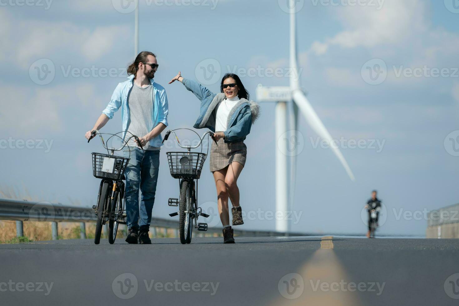 jovem mulher equitação uma bicicleta com dela namorado em a estrada foto