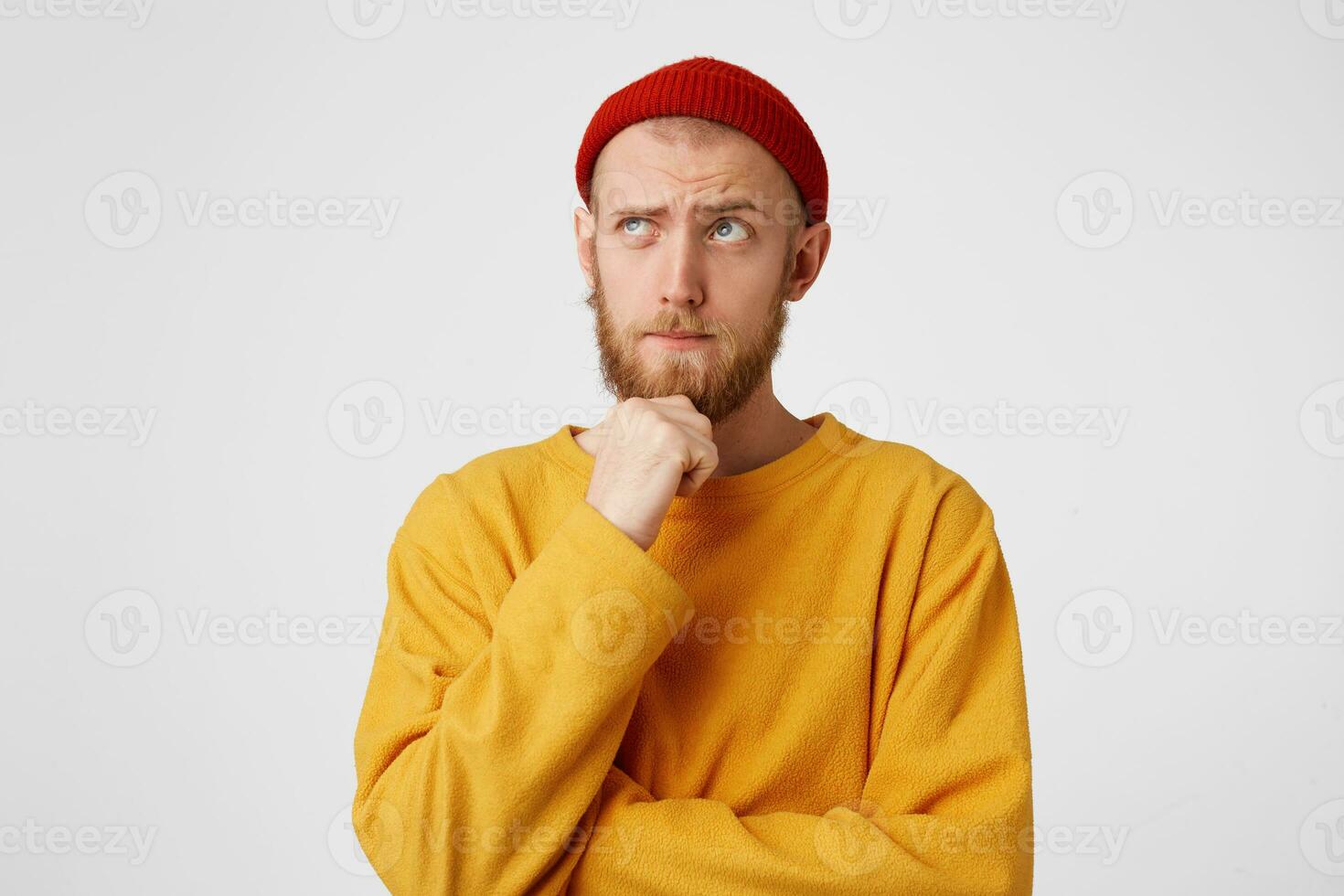 foto do pensativo homem isolado sobre branco fundo muro. olhando de lado.esperando para inspiração. pensando jovem masculino segurando punho em queixo