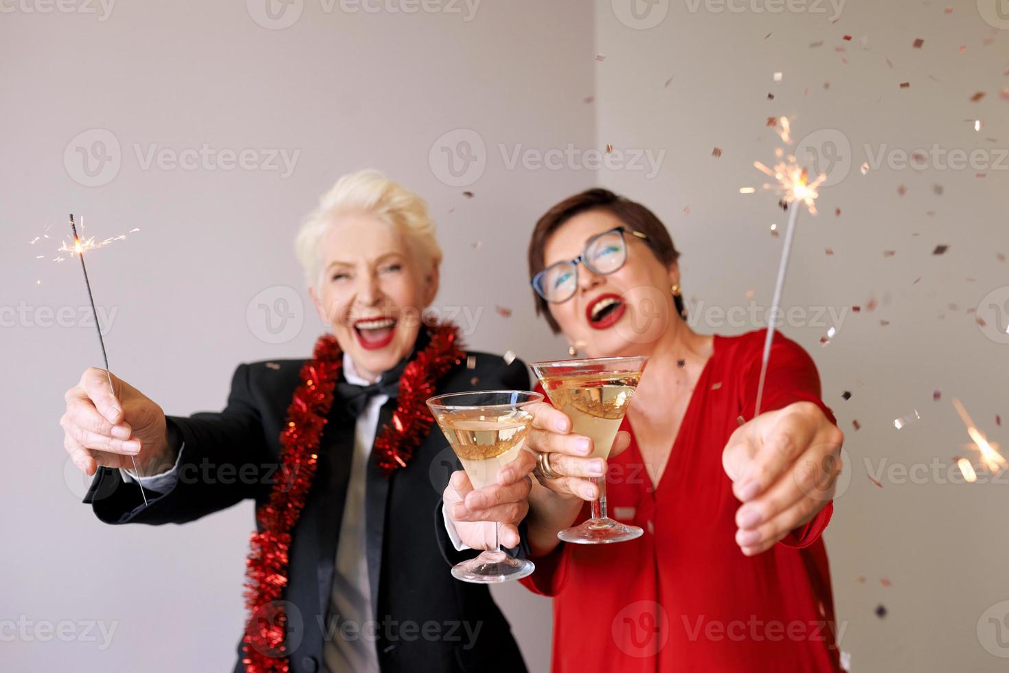 duas belas mulheres maduras maduras elegantes comemorando o ano novo. diversão, festa, estilo, conceito de celebração foto