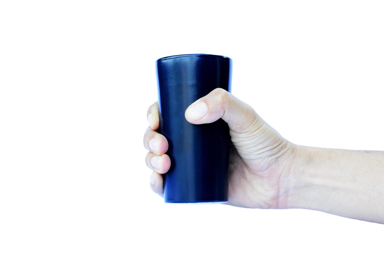 mão direita segurando um copo de cerâmica azul isolado em um fundo branco foto