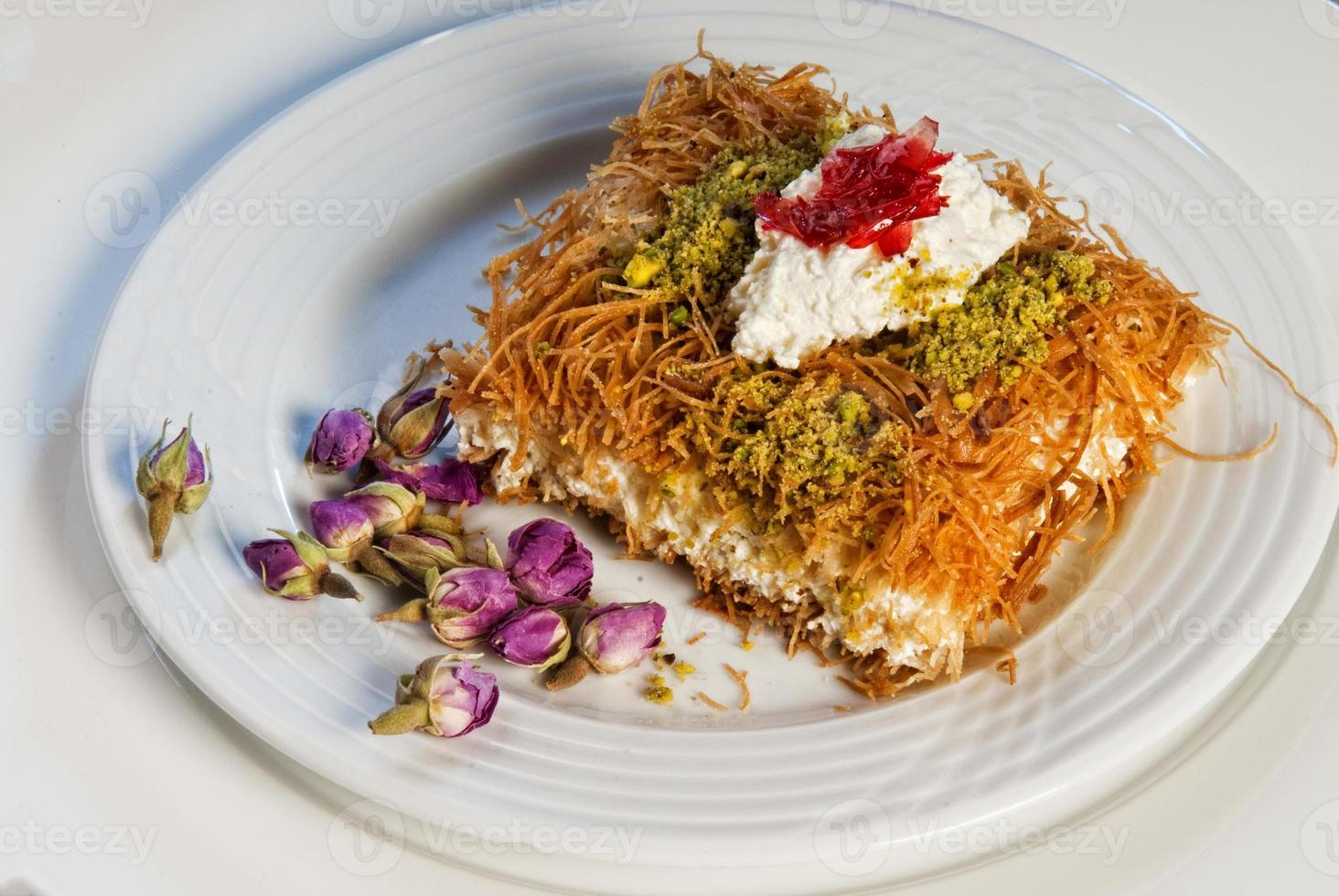 prato de baklava de doces árabes orientais com rosa foto