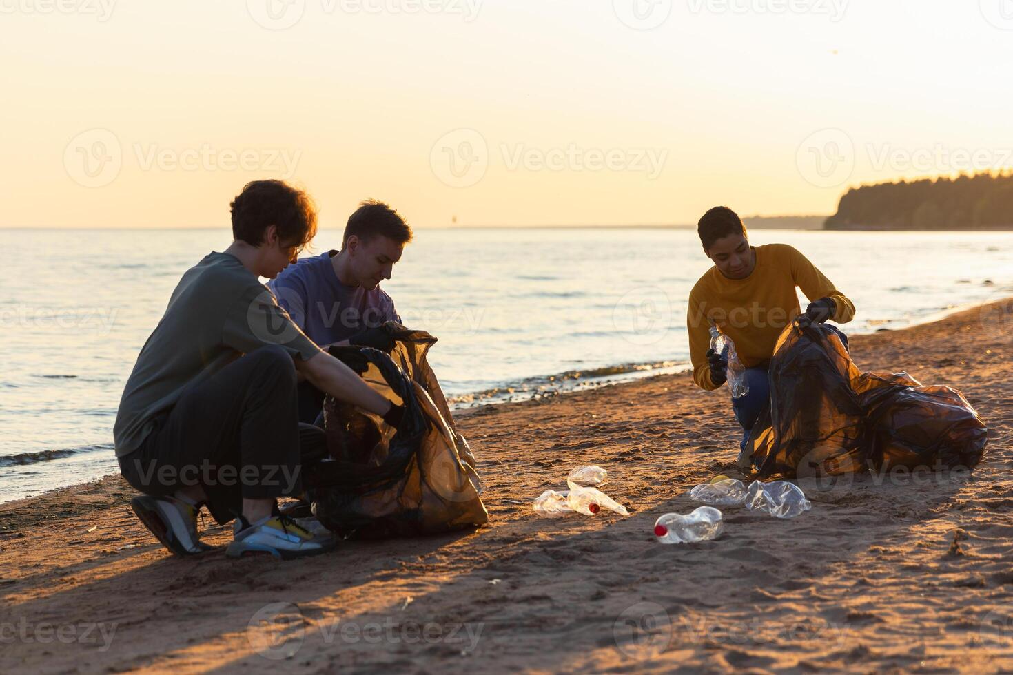 terra dia. voluntários ativistas coleta lixo limpeza do de praia costeiro zona. mulher e mans coloca plástico Lixo dentro lixo saco em oceano costa. de Meio Ambiente conservação costeiro zona limpeza foto