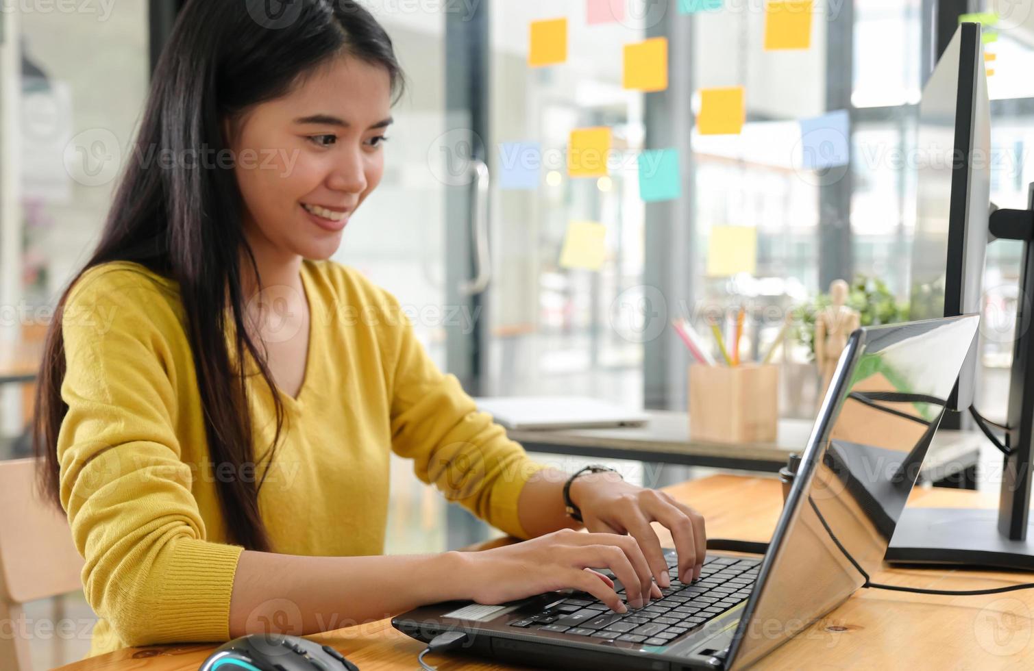 jovem profissional usa um laptop para trabalho e reuniões online, ela trabalha em casa. foto