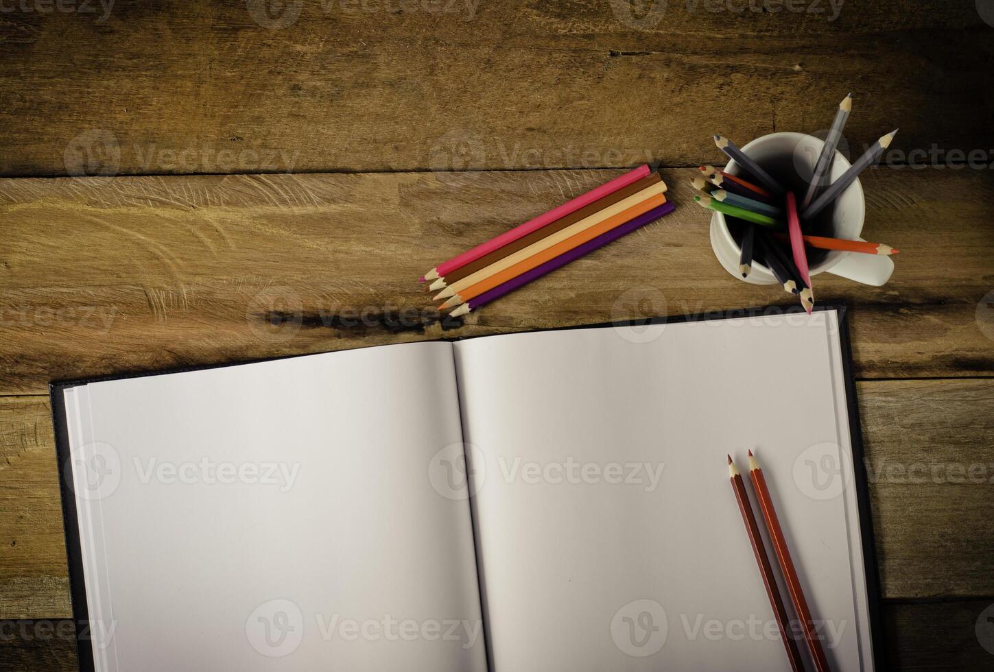 cor lápis e caderno de desenho em madeira mesa foto