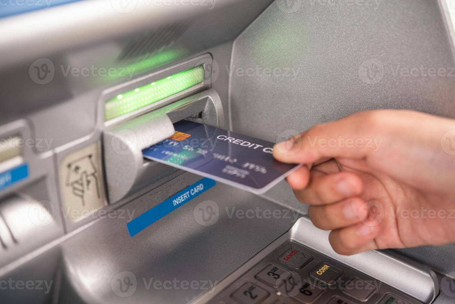 mão inserindo com uma crédito cartão para dentro banco máquina . homem usando a atm máquina com crédito cartão para retirar dinheiro foto