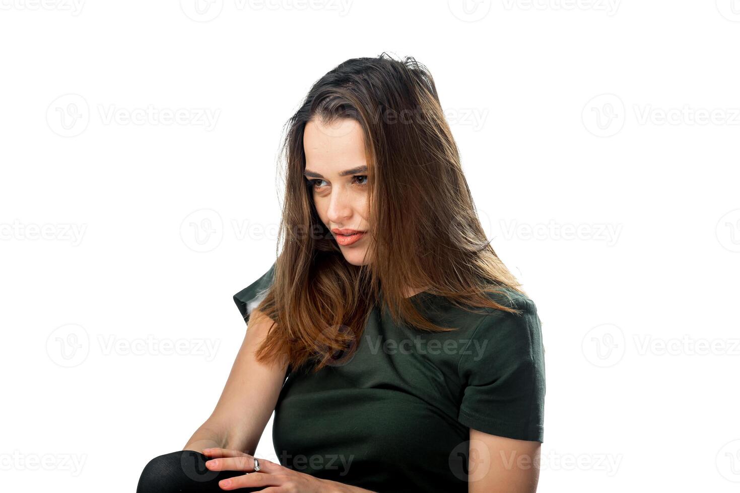 uma mulher sentado dentro uma verde camisa. uma mulher dentro uma verde camisa é sentado baixa foto