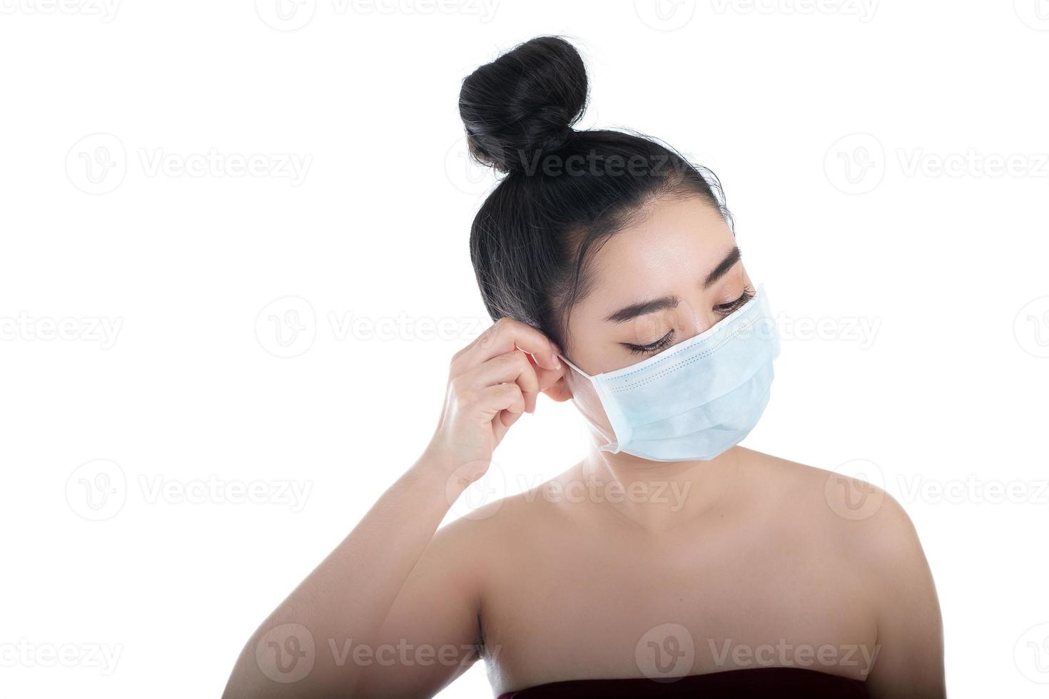bela jovem asiática colocando uma máscara médica para se proteger de doenças respiratórias transmitidas pelo ar como a gripe covid-19 pm2.5 poeira e poluição, conceito de infecção por vírus de segurança para mulheres, câmera foto