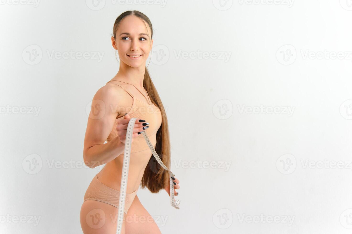 mulher medindo dela fino corpo isolado em branco fundo. foto