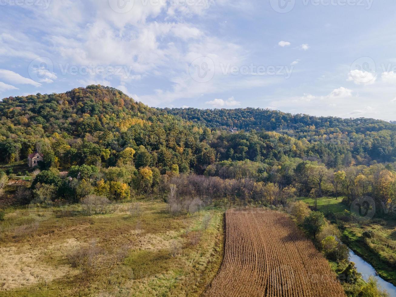 vista aérea de uma fazenda com penhascos no outono com cores naturais e céu azul campo de milho colhido em ambiente aberto foto