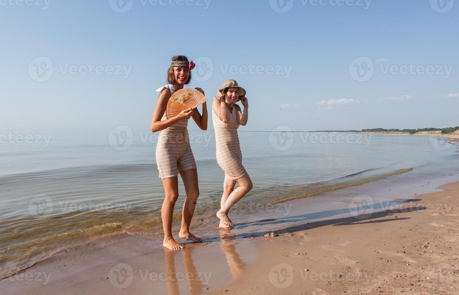 dois jovem mulheres dentro retro maiôs de a mar foto