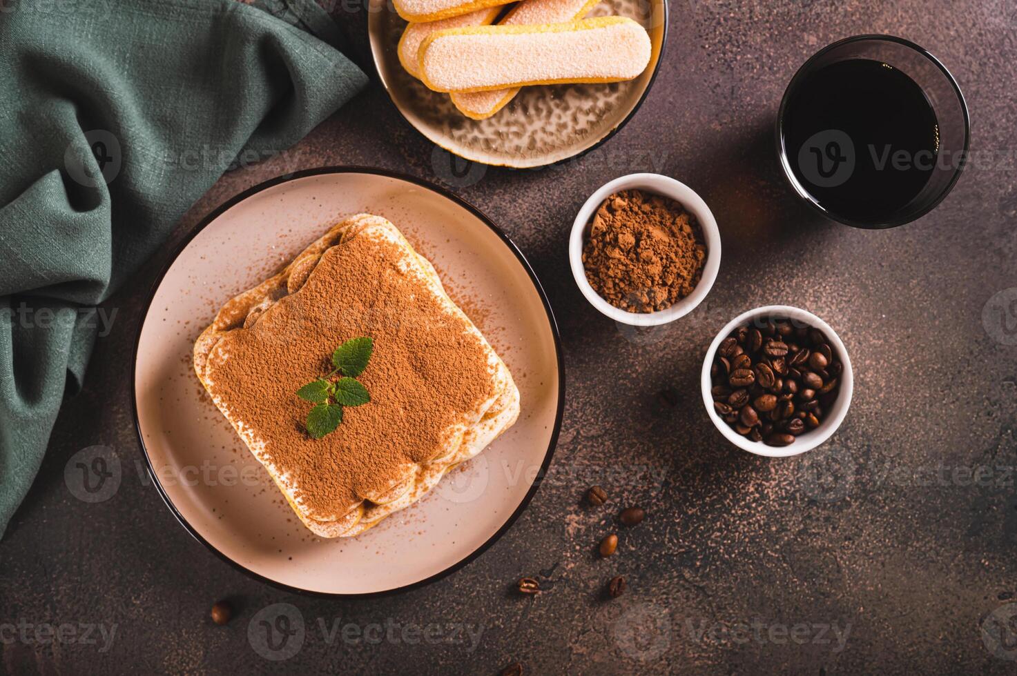 Tiramisu clássico sobremesa com biscoitos, mascarpone e café em uma prato em a mesa topo Visão foto