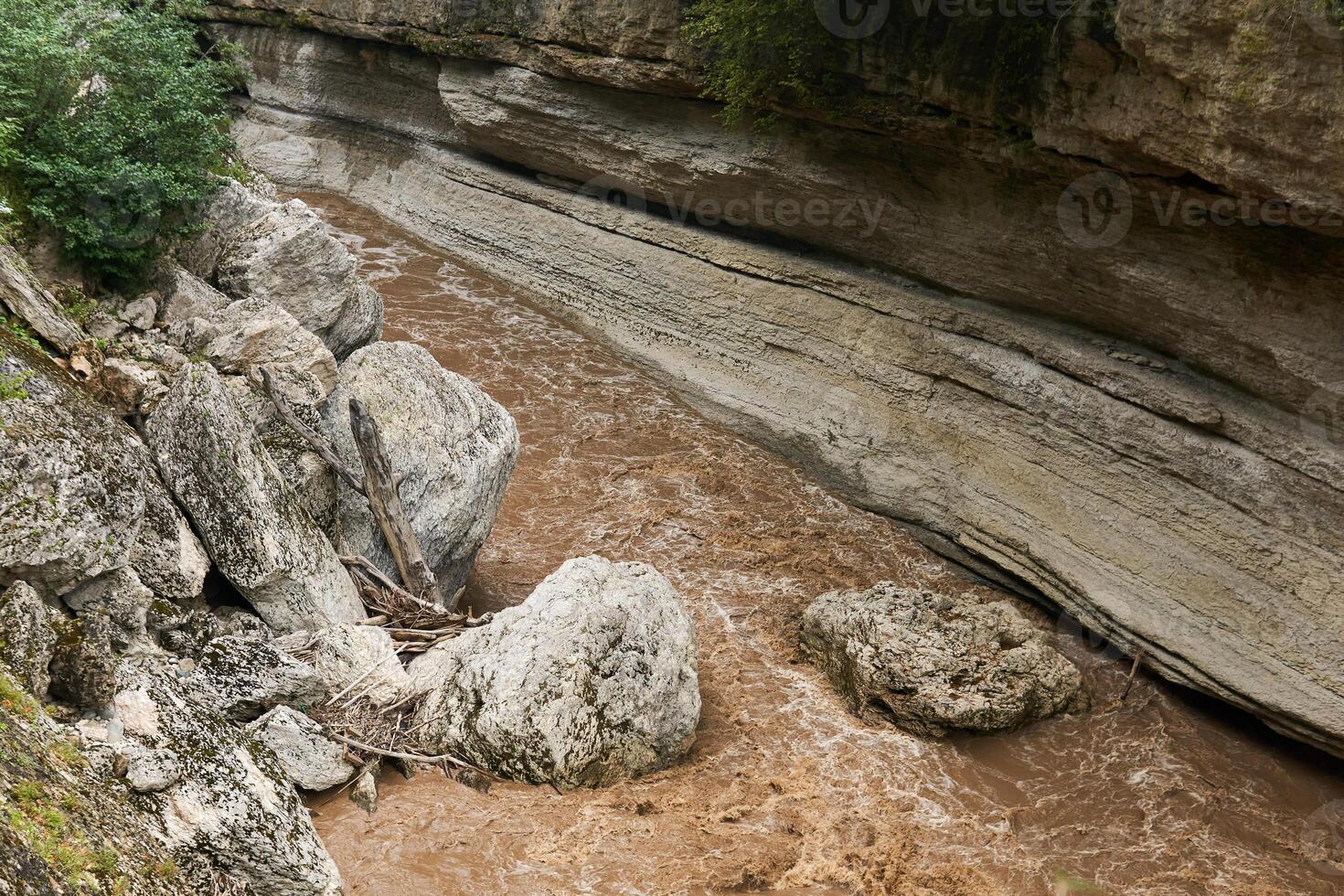 montanha desfiladeiro com pedras este caiu para dentro a rio durante a inundar foto