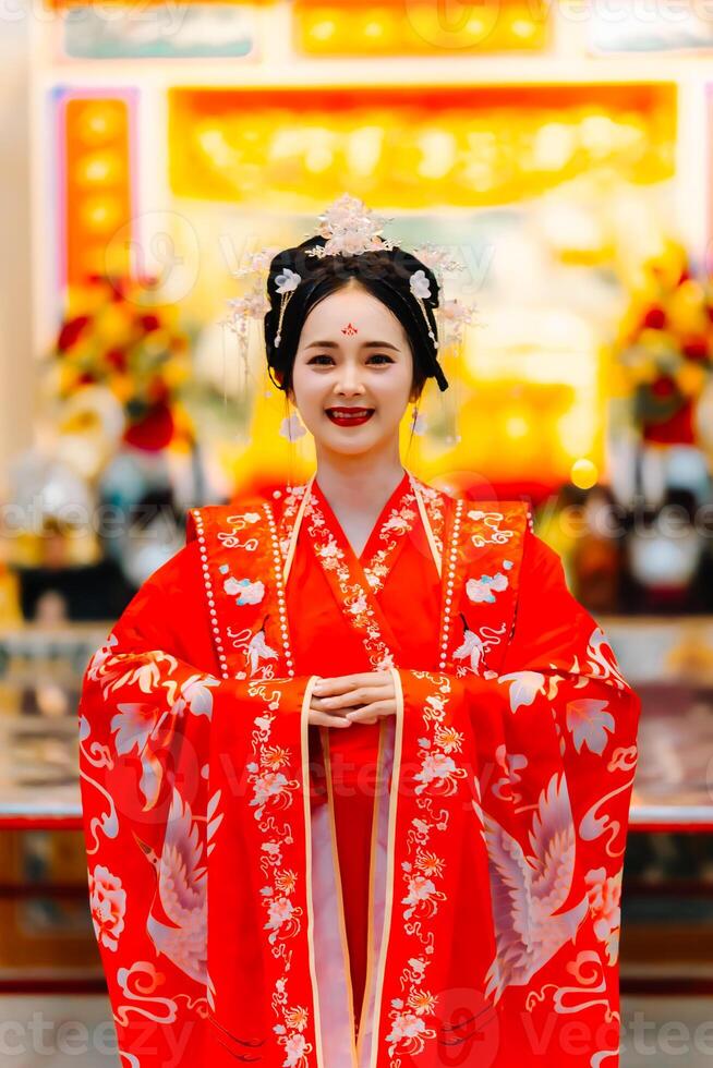 mulher vestir China Novo ano. retrato do uma mulher. pessoa dentro tradicional fantasia. mulher dentro tradicional fantasia. lindo jovem mulher dentro uma brilhante vermelho vestir e uma coroa do chinês rainha posando. foto