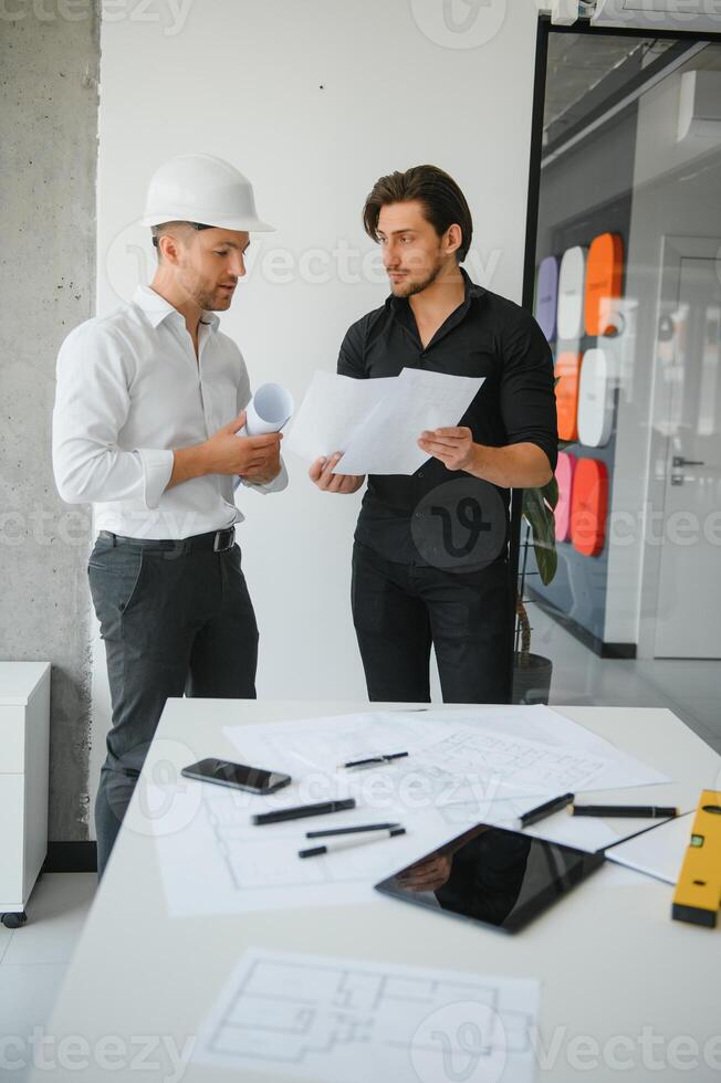 engenheiros estão ajudando a projetar o trabalho em plantas e colaborar na análise estrutural dos tipos de projeto. foto