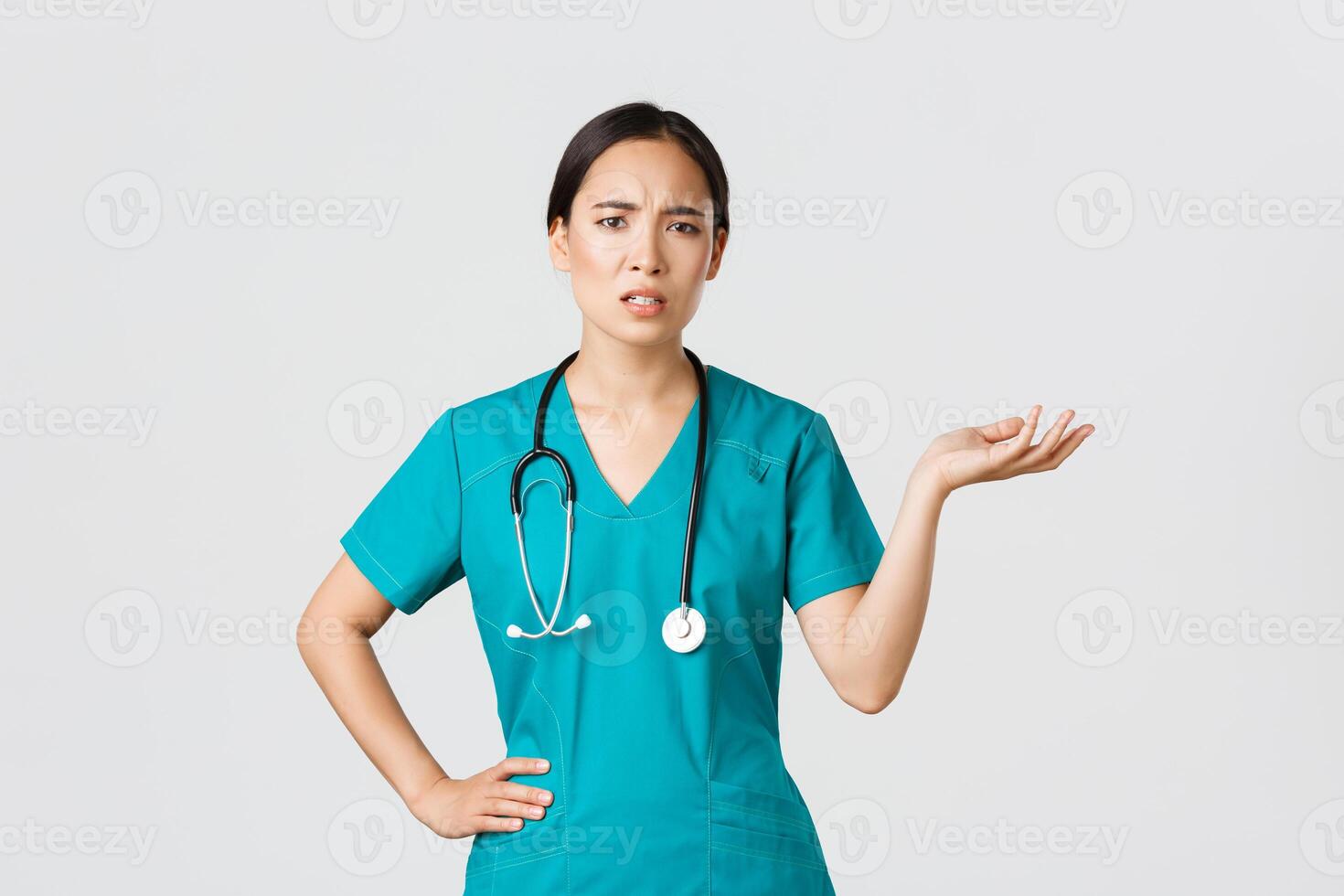 COVID-19, cuidados de saúde trabalhadores, pandemia conceito. frustrado e irritado ásia fêmea doutor, enfermeira dentro esfrega levantar 1 mão e olhando questionado e puto, reclamando alguma coisa foto