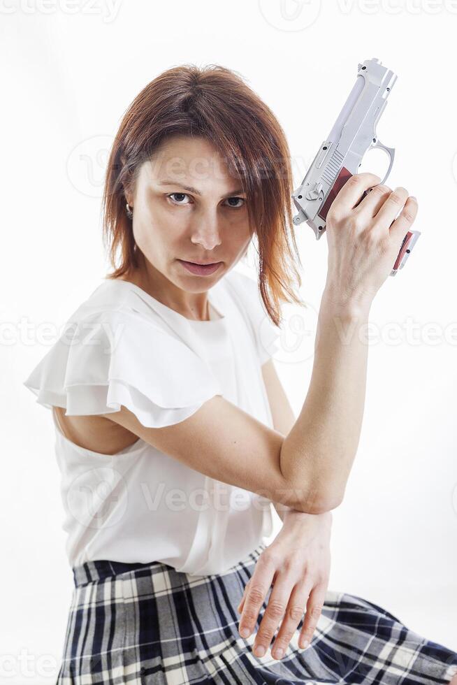 sexy mulher posando com arma de fogo em branco fundo foto