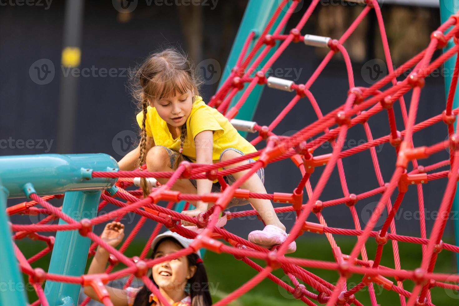 jovem meninas cutucando cabeça através escalada corda atividade usando isto Como quadro. foto