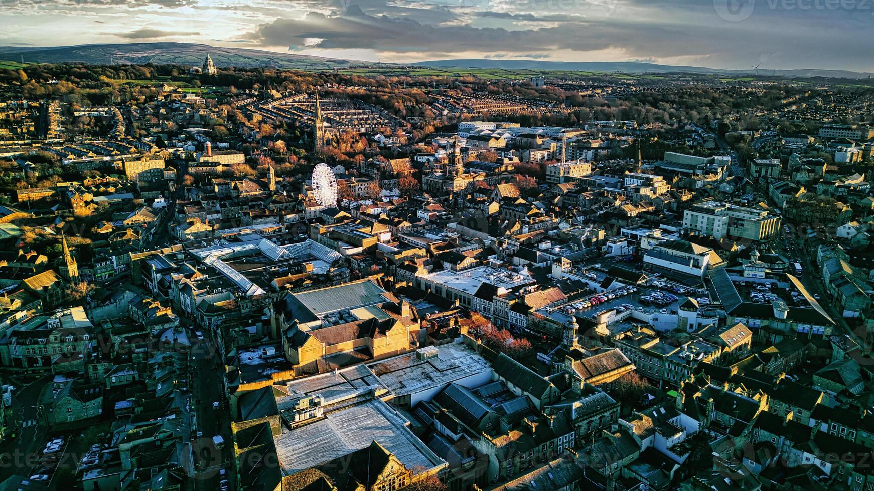 aéreo Visão do uma cidade lancaster às pôr do sol com caloroso iluminação destacando a edifícios e ruas, exibindo a urbano panorama. foto
