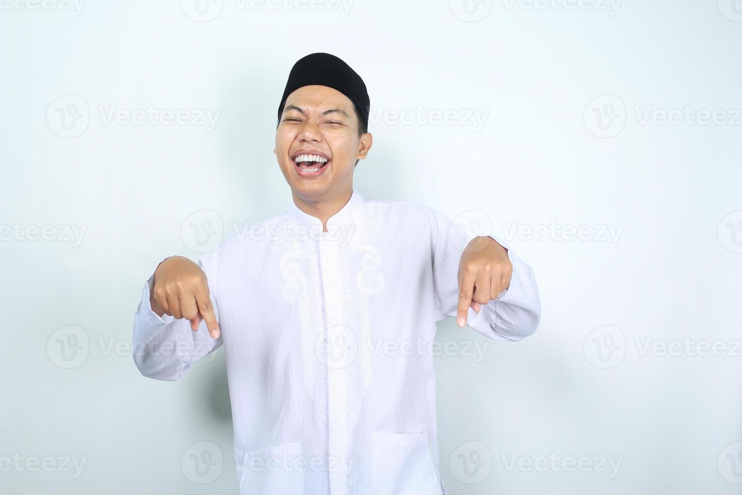 rindo ásia muçulmano homem apontando baixa isolado em branco fundo foto