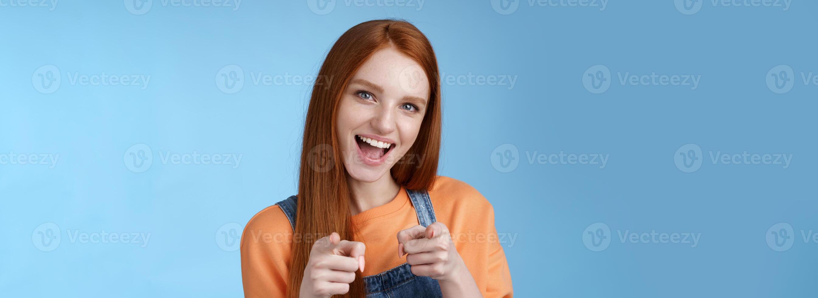 meu parabéns. atrevido confiante entusiasmado jovem atraente gengibre menina azul olhos apontando dedo pistolas Câmera sorridente amplamente torcendo amigo fez ótimo trabalho felicitar você impressionante desempenho foto