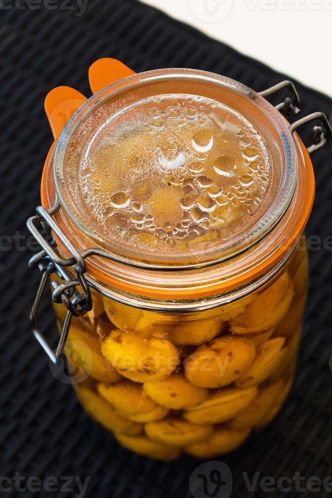 esterilizado mirabelle ameixas, caseiro frutas dentro xarope para a inverno, preserva nutrientes foto