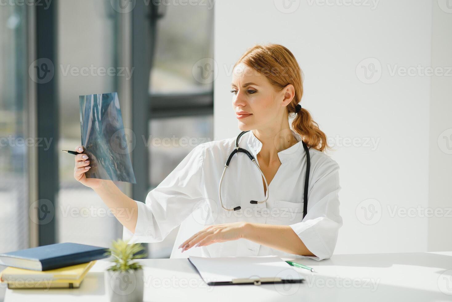 retrato do atraente fêmea médico segurando prancheta enquanto em pé dentro clínica. foto