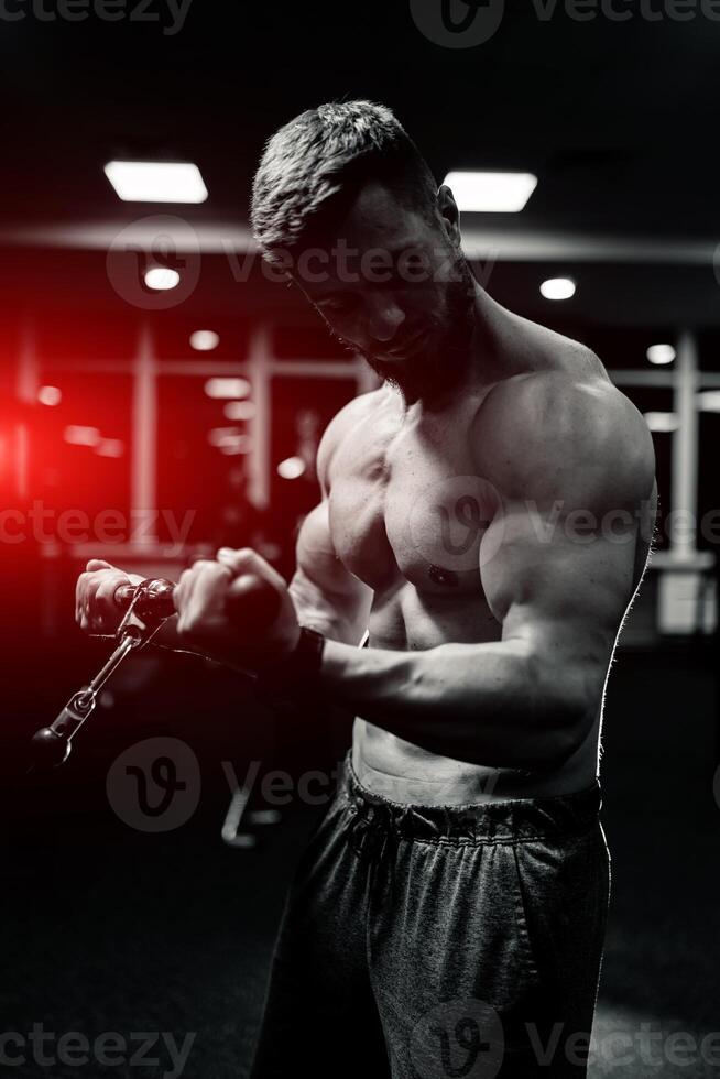 atleta Forte desportivo fisiculturista. bonito muscular homem posando dentro a academia. foto