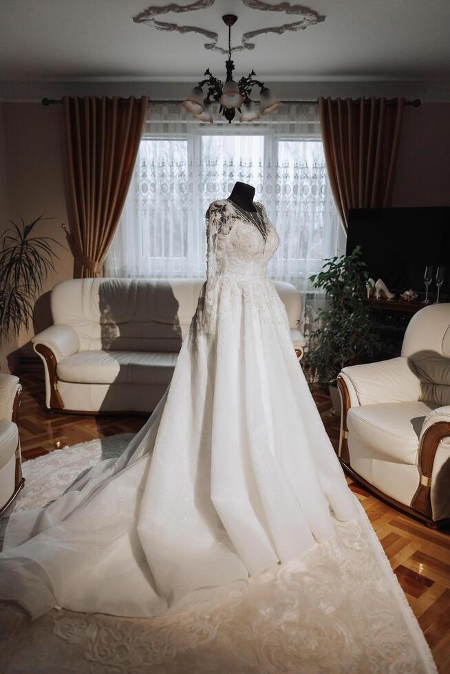 quarto interior com Casamento vestir preparado para a cerimônia. uma lindo exuberante Casamento vestir em uma manequim dentro uma hotel sala. foto