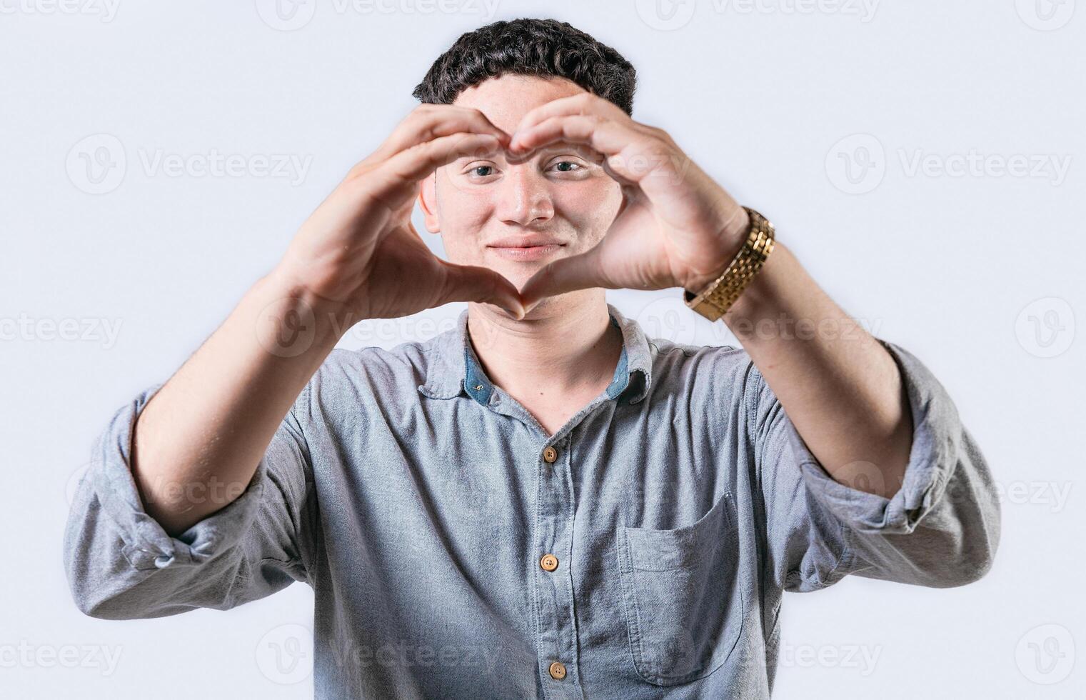 bonito jovem homem fazer coração forma com mãos isolado. sorridente latim homem fazer coração forma com mãos foto