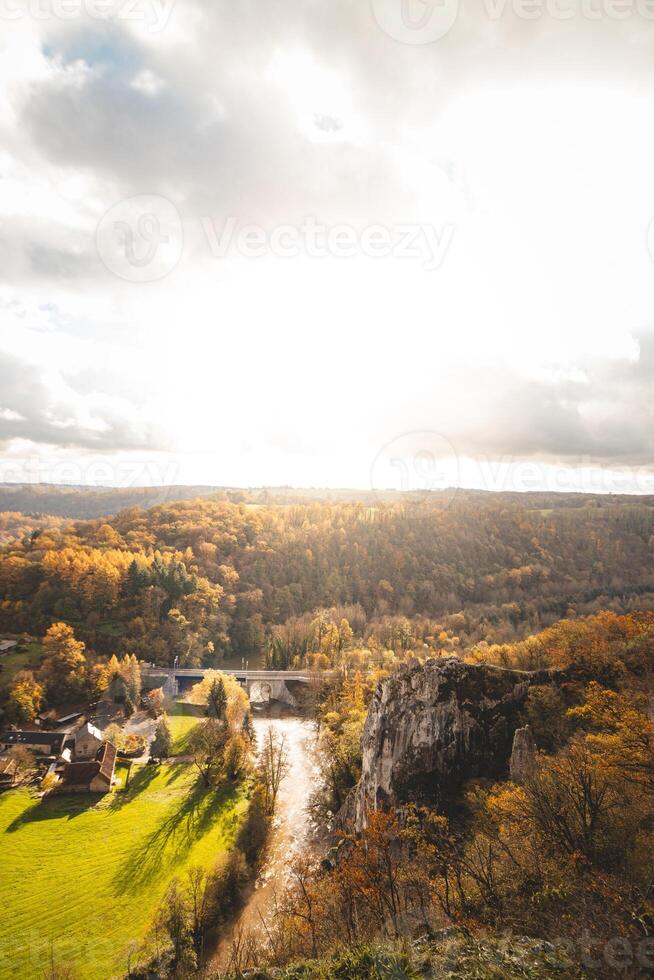 rochoso meio Ambiente perto a Cidade do dinant com uma curso de água este formulários natural meandros dentro outono cor. a pôr do sol ilumina uma colorida floresta foto