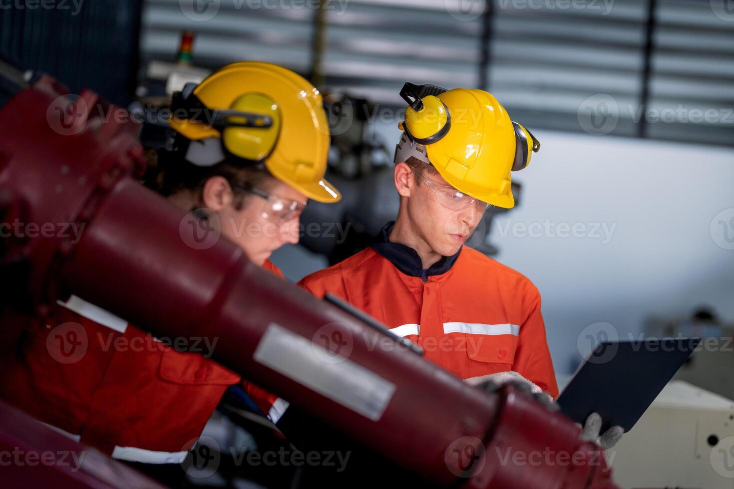 grupo do masculino engenheiro trabalhadores manutenção automático robótico braço máquina dentro uma Sombrio quarto fábrica. trabalhador verificação e reparação automático robô mão máquina. trabalhador vestindo segurança óculos e capacete. foto