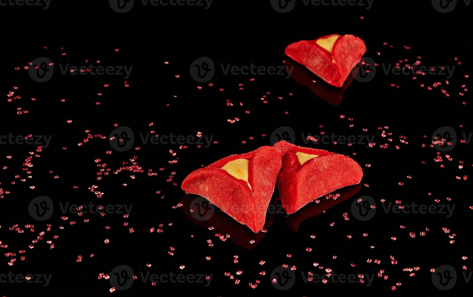 Hamãs orelhas - hamantash estão vermelho, com a gosto do vermelho veludo em uma Preto fundo com reflexão foto