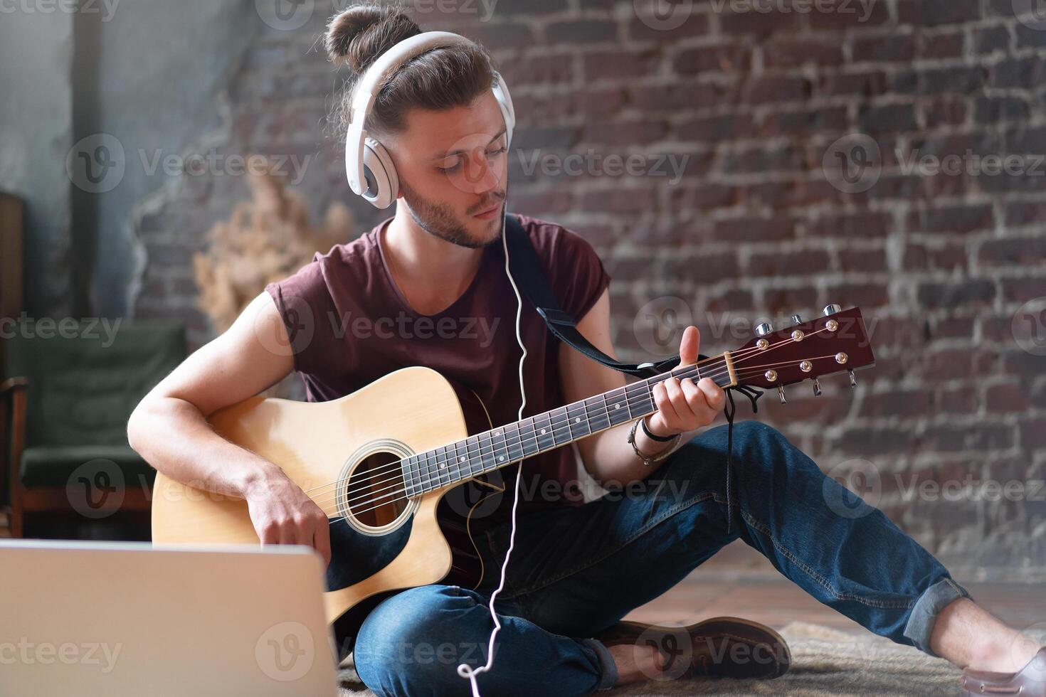 caucasiano jovem adulto Aprendendo guitarra conectados música classe com distante professor computador Móvel dispositivo foto