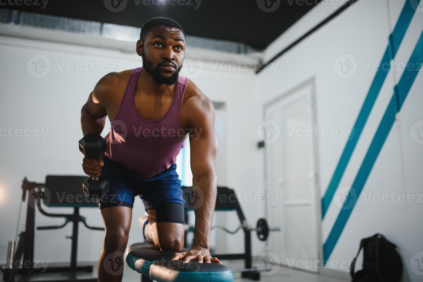 peso Treinamento africano fazendo musculação dentro academia. foto