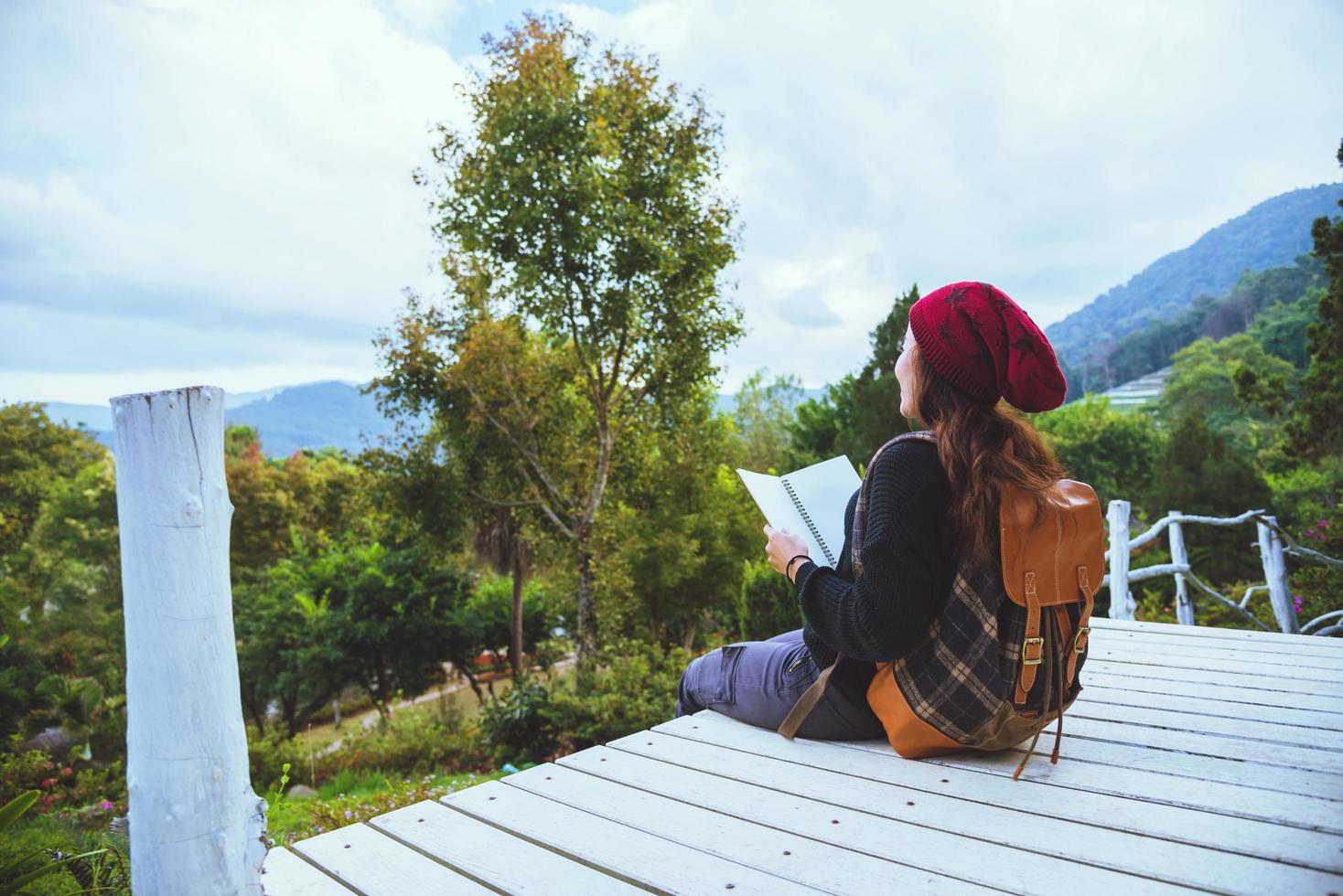 mulheres asiáticas relaxam no feriado. estudo ler um livro. ler um livro no jardim da montanha. Na Tailândia foto