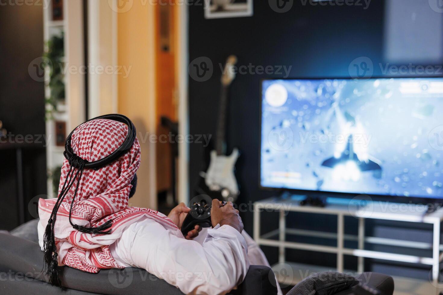 árabe homem é concentrado e imerso, ele controles a jogabilidade usando uma console controlador. a digital mundo vem vivo em dele televisão exibição Como ele agarra sem fio tecnologia. foto