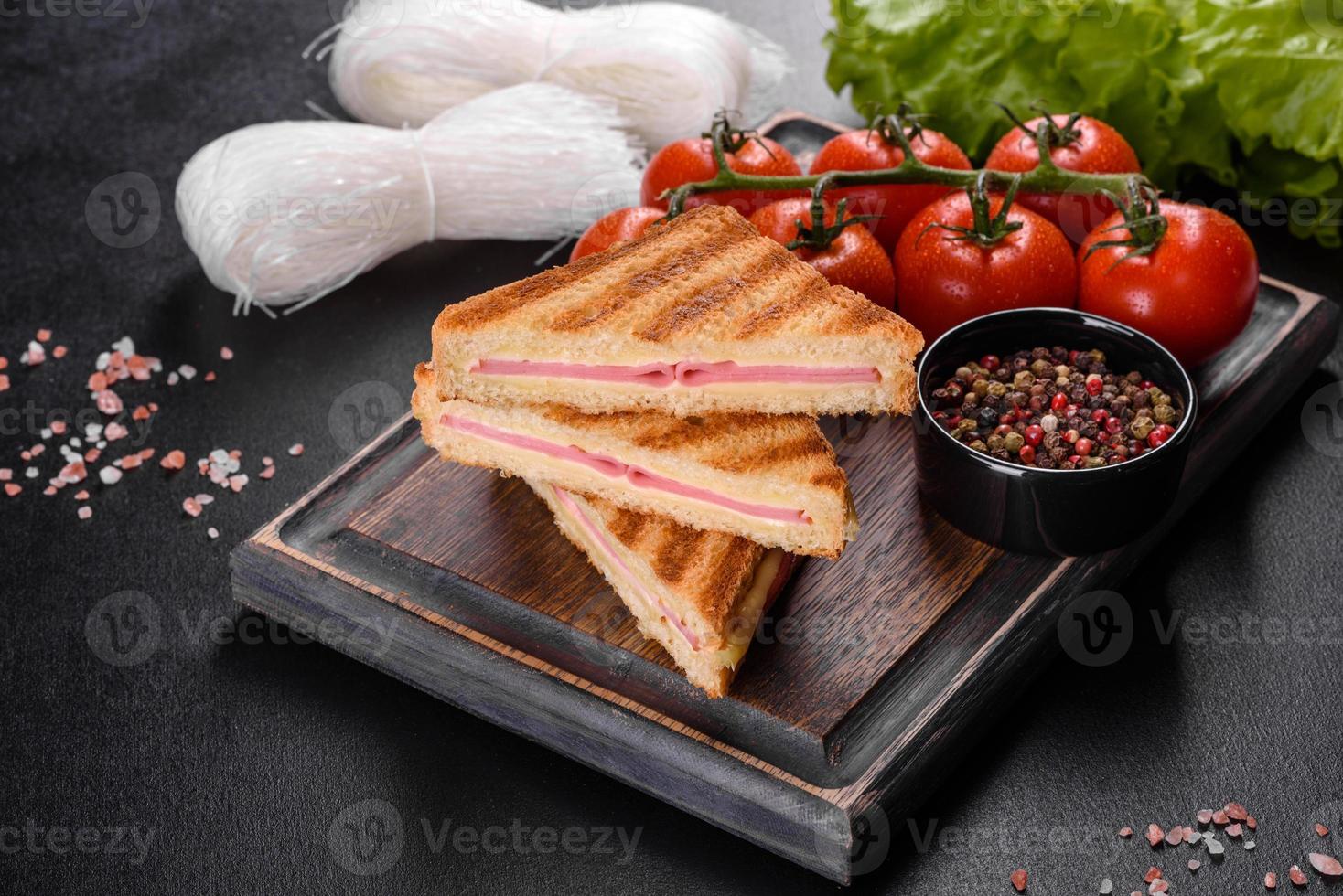 sanduíche com presunto, queijo, tomate, alface e pão torrado foto