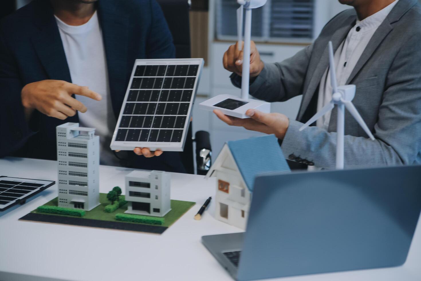 dois jovem engenheiros perícia dentro solar célula instalação Encontros e discussão dentro a trabalho. planejamento para instalar solar fotovoltaico painéis em cobertura topo dentro a escritório quarto com fábrica construção plano. foto