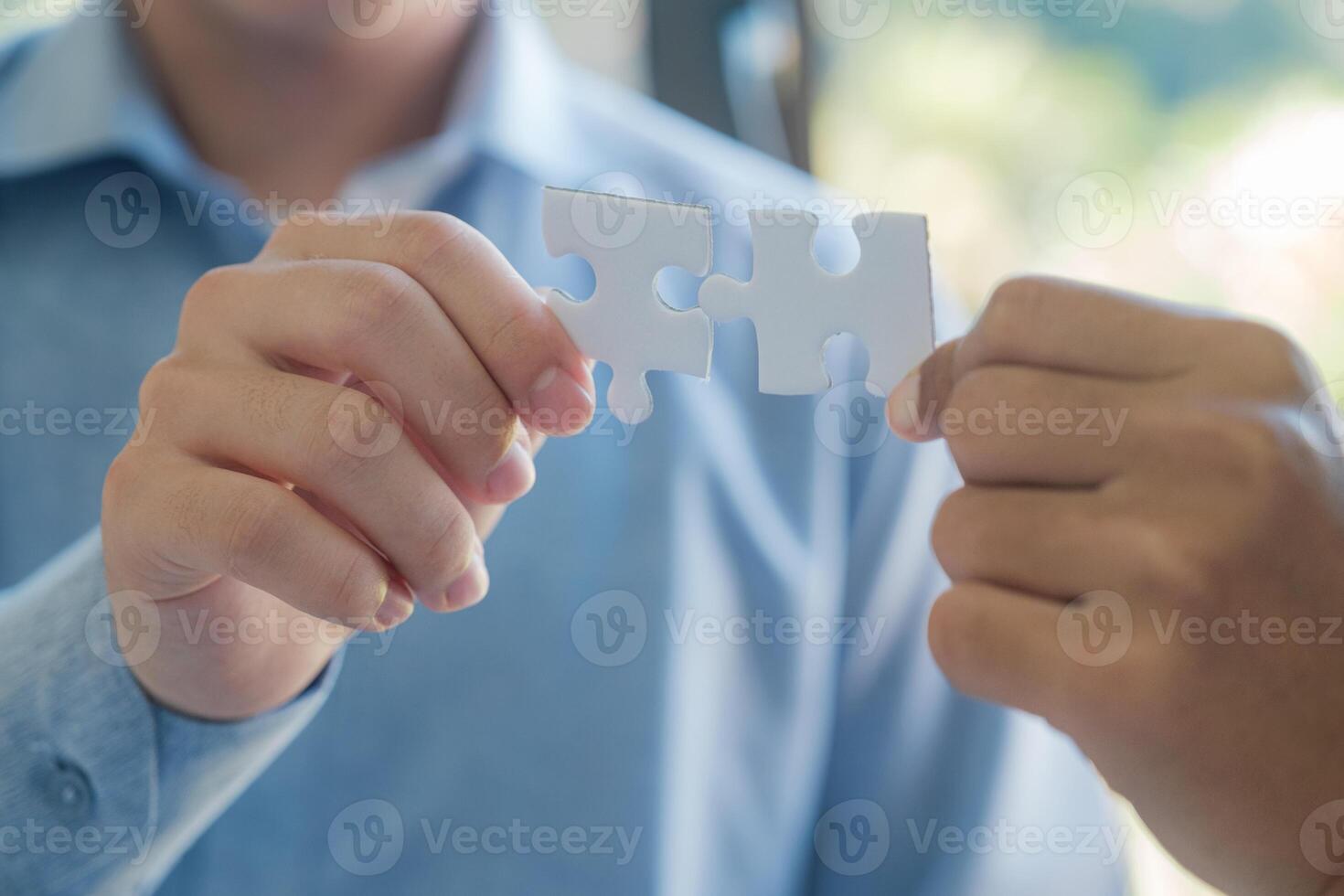 dois pessoas segurando uma enigma peça junto. conceito do trabalho em equipe e colaboração. foto