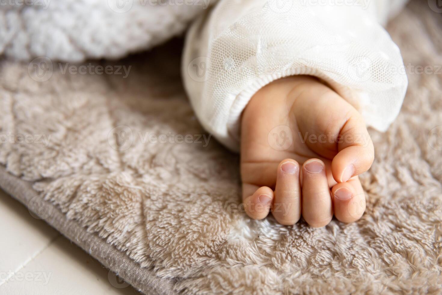 uma esquerda mão do dormindo ásia bebê em a tapete foto