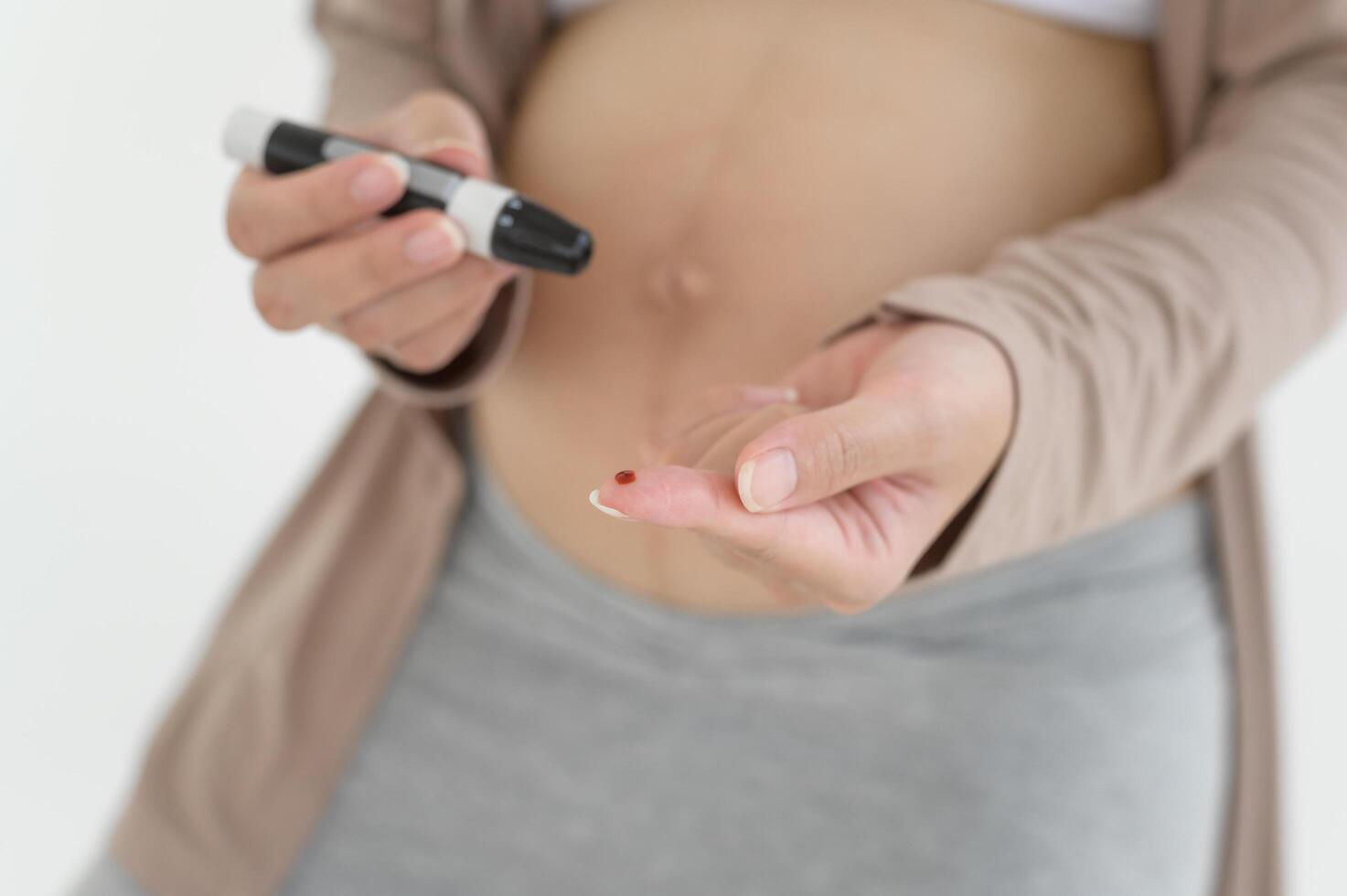 grávida mulher verificação sangue açúcar nível de usando digital glicose metro, saúde Cuidado, medicamento, diabetes, glicemia conceito foto