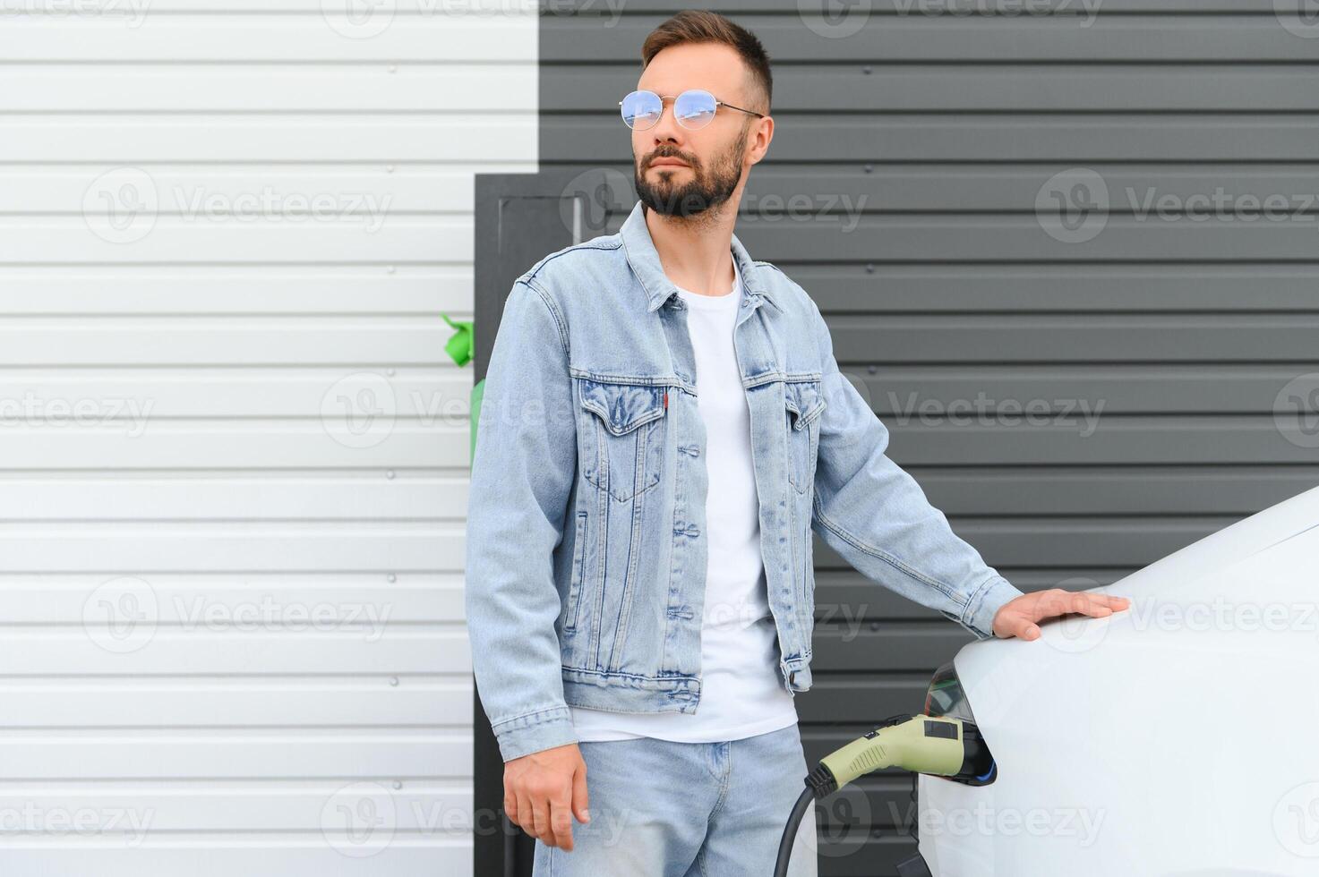 homem em pé de dele elétrico carro foto