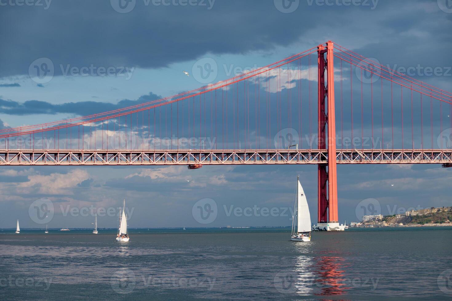 barcos Navegando em a tagus rio dentro Lisboa, Portugal. 25 abril ponte dentro a fundo. foto