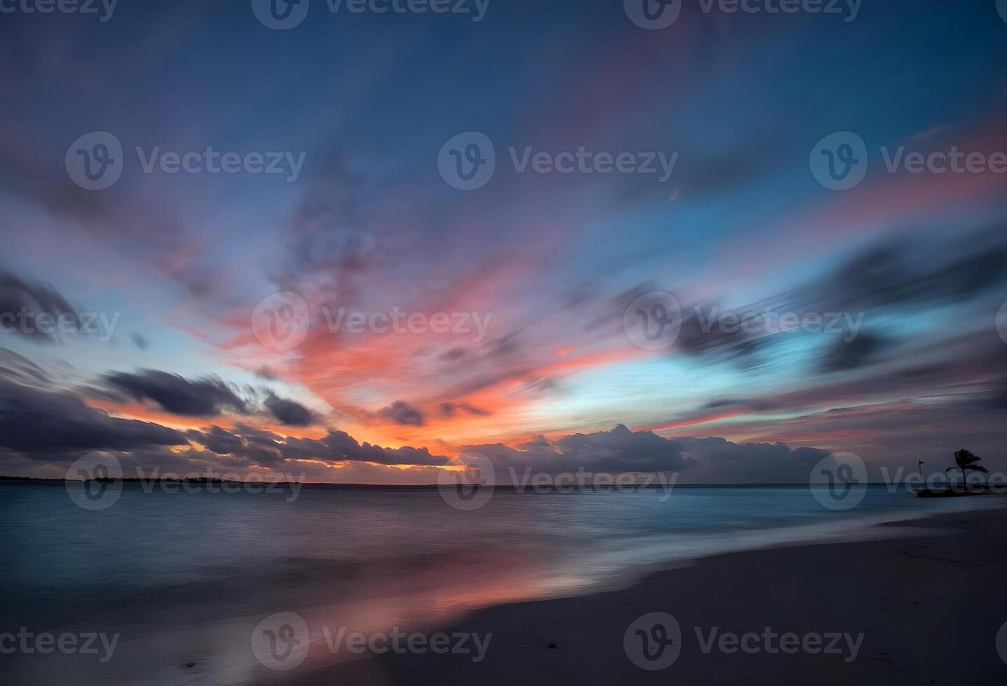 a Sol configuração sobre a oceano com pedras dentro a primeiro plano foto