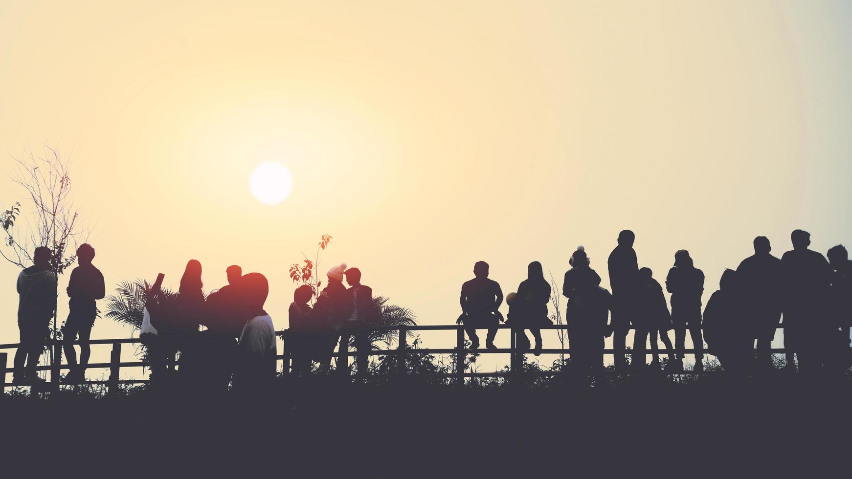 os asiáticos viajam relaxam no feriado. as pessoas ficam olhando para o sol pela manhã. levantar-se para o nascer do sol na montanha foto